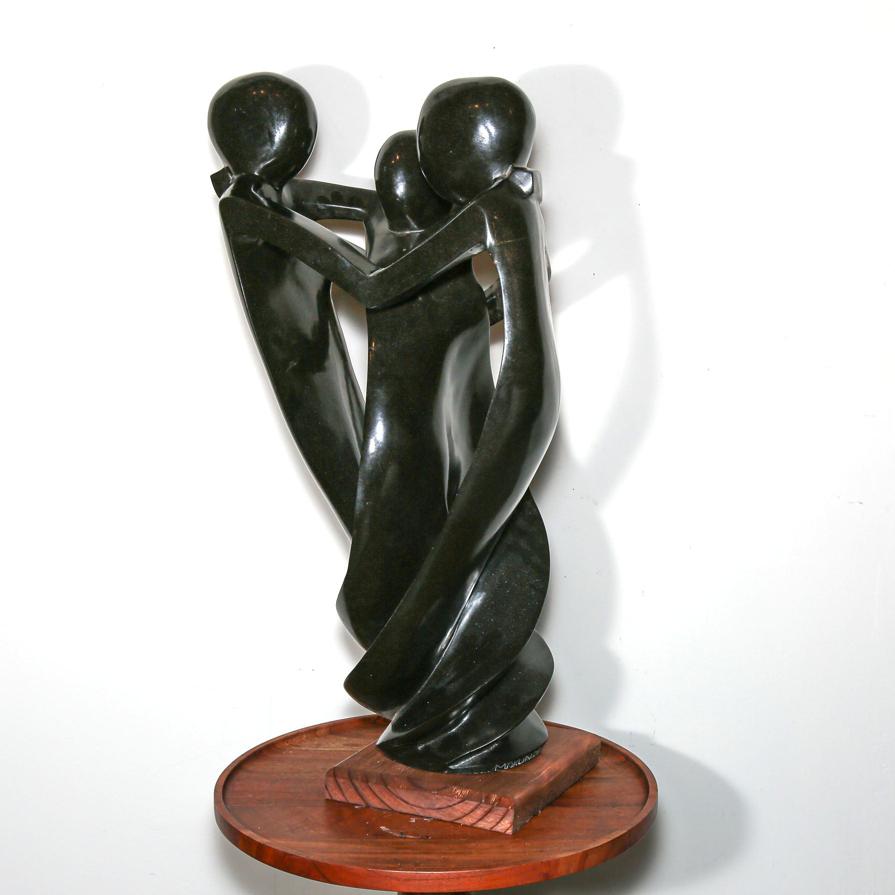 Black Sculpture of three family members hugging