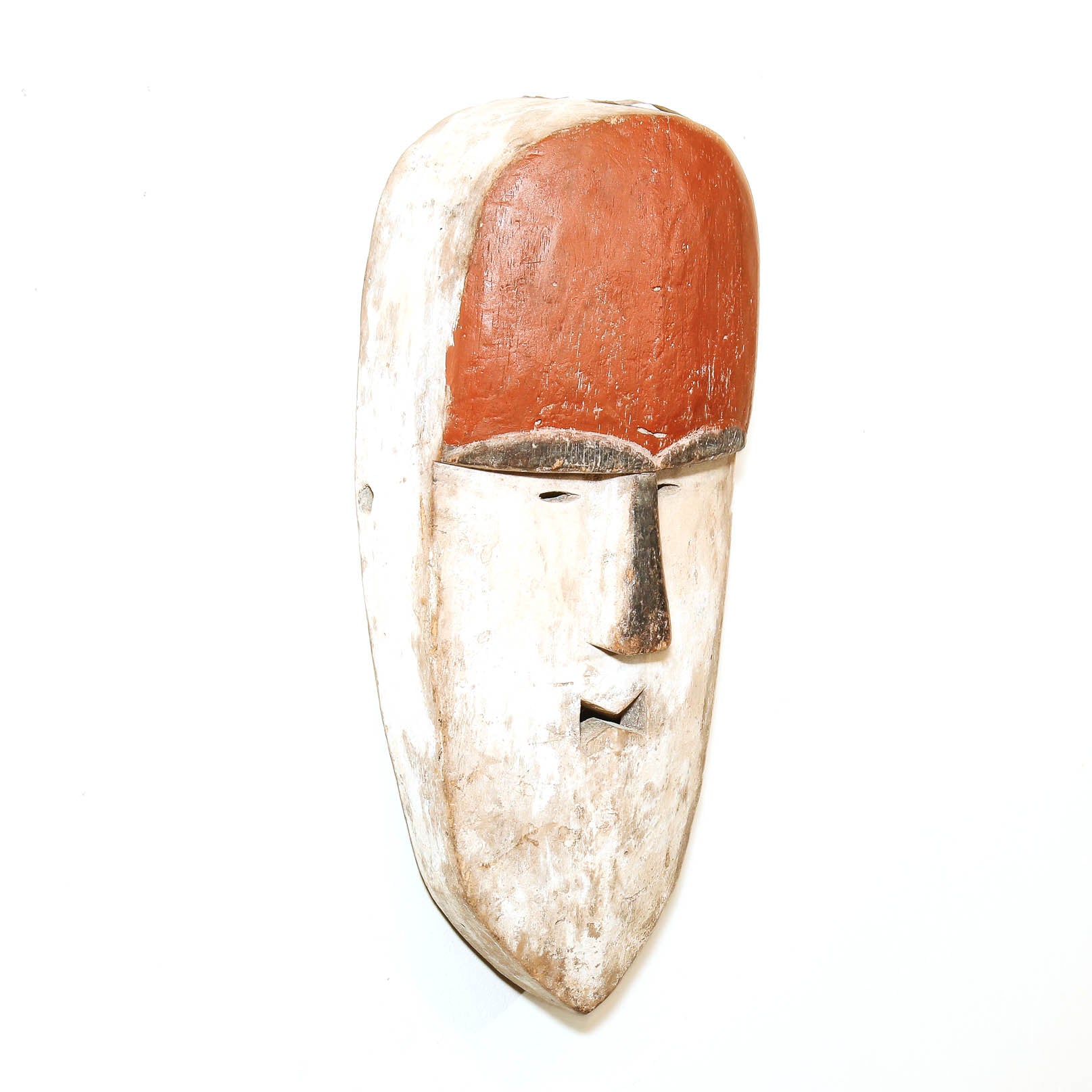 Simple Pende style African mask with red and white painted finish