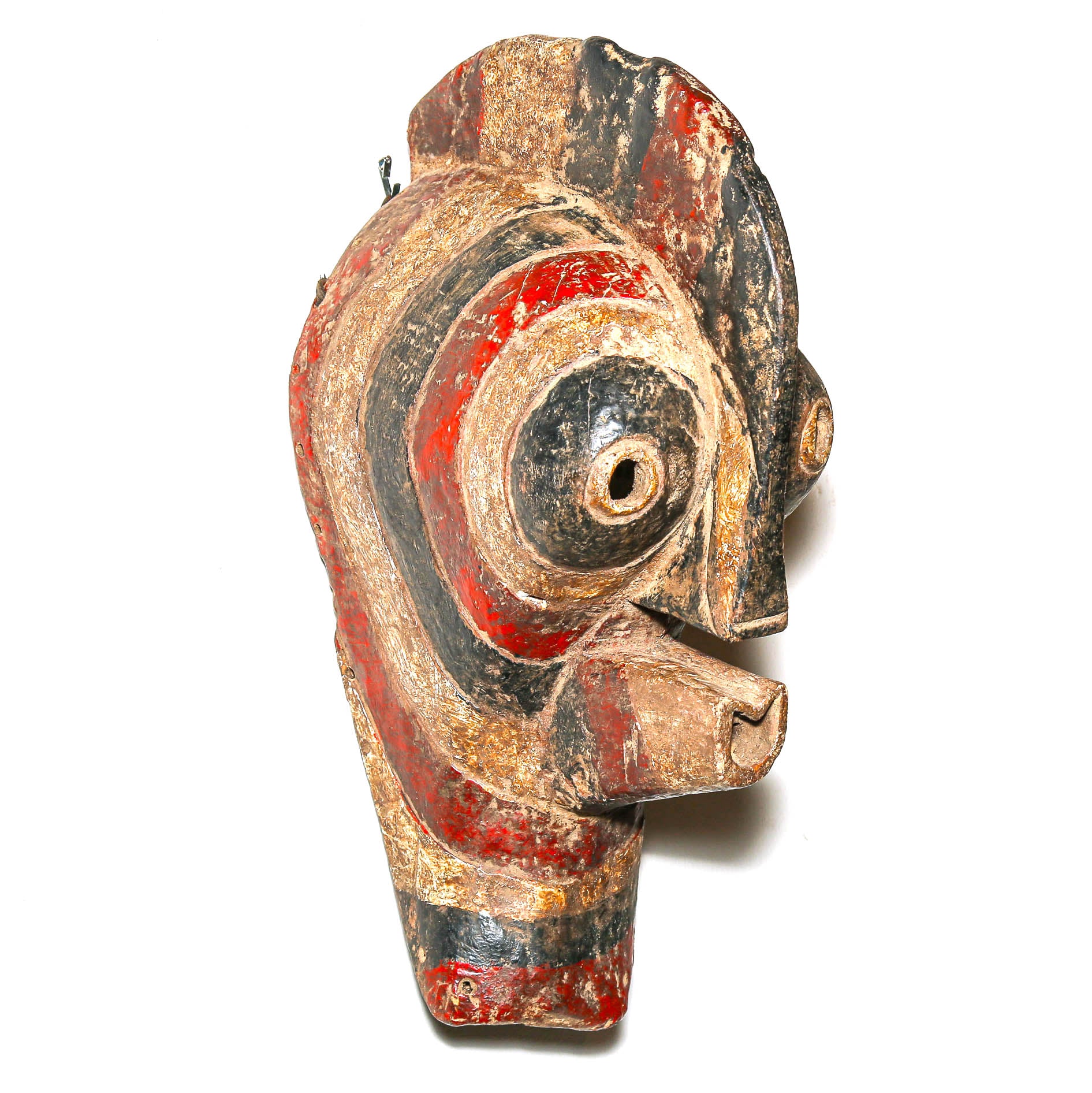 Traditional wooden mask from Africa with red, black, and gold colors on a white background