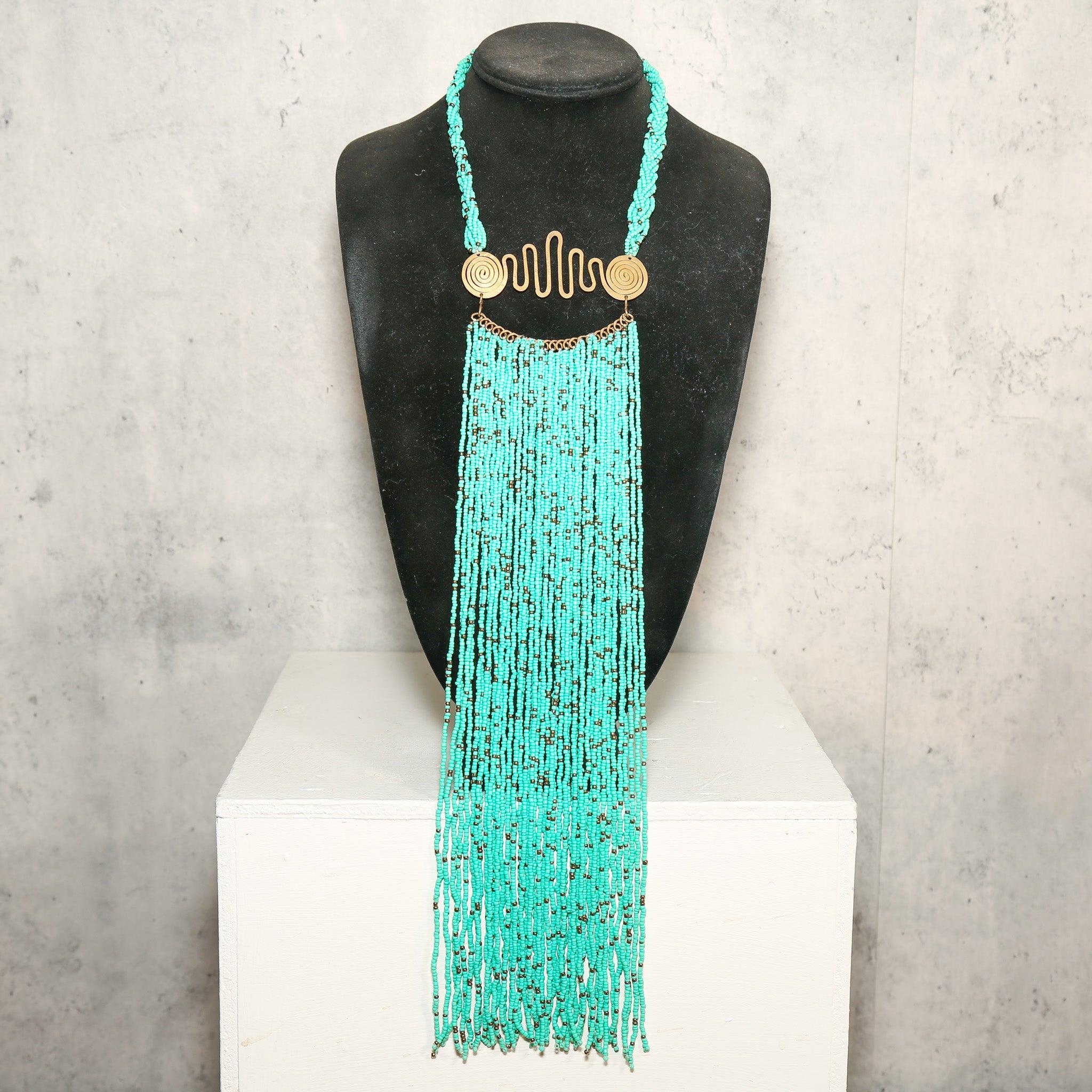 Teal Zulu Beaded Necklace from South Africa on a display in front