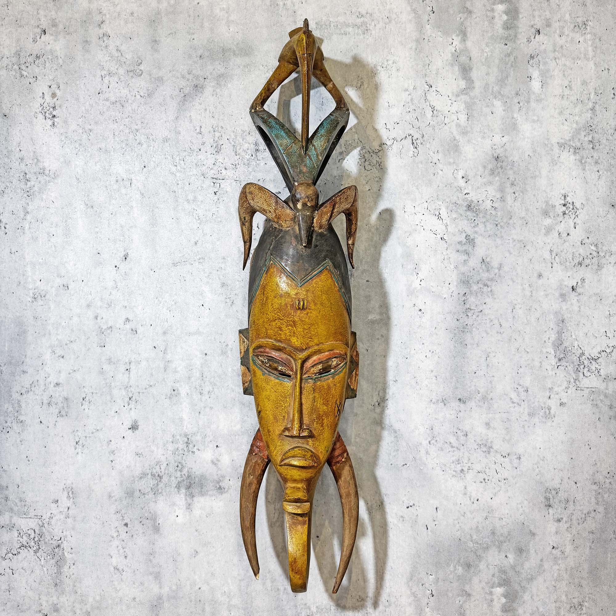 Guro Mask from Côte d'Ivoire Yellow-Green as a wall decoration idea