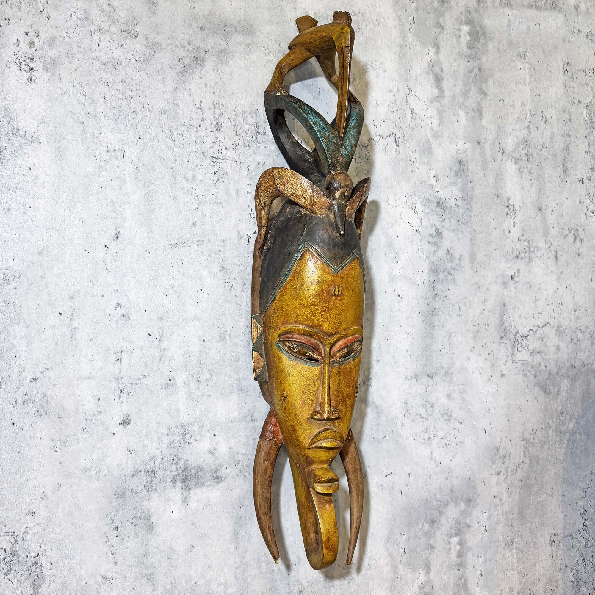 Left side of Guro Mask from Côte d'Ivoire Yellow-Green as a wall decoration idea