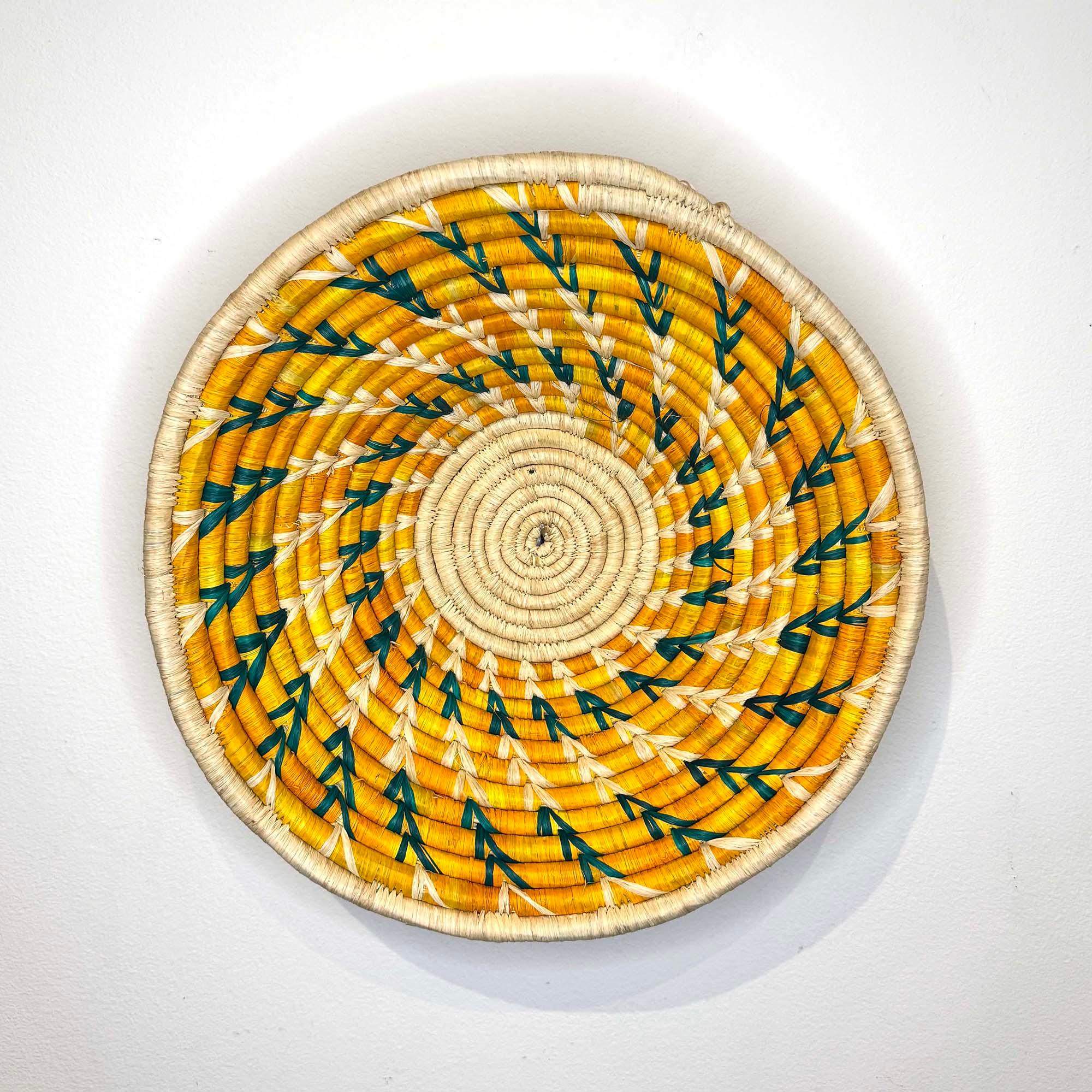 Yellow-Green Woven Basket Handcrafted in Uganda as a wall decor idea