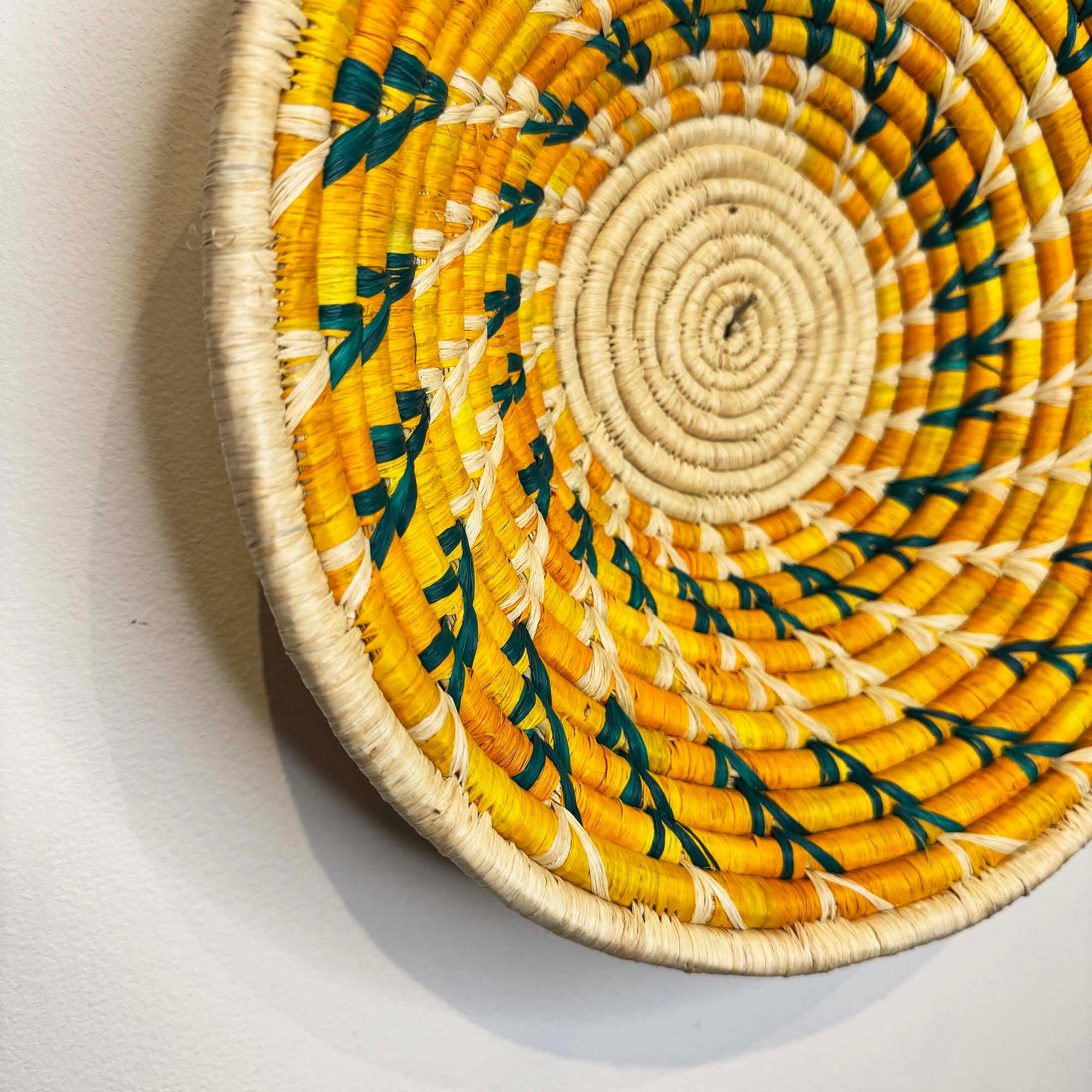 Yellow-Green Woven Basket Handcrafted in Uganda as a wall decor idea with a close up