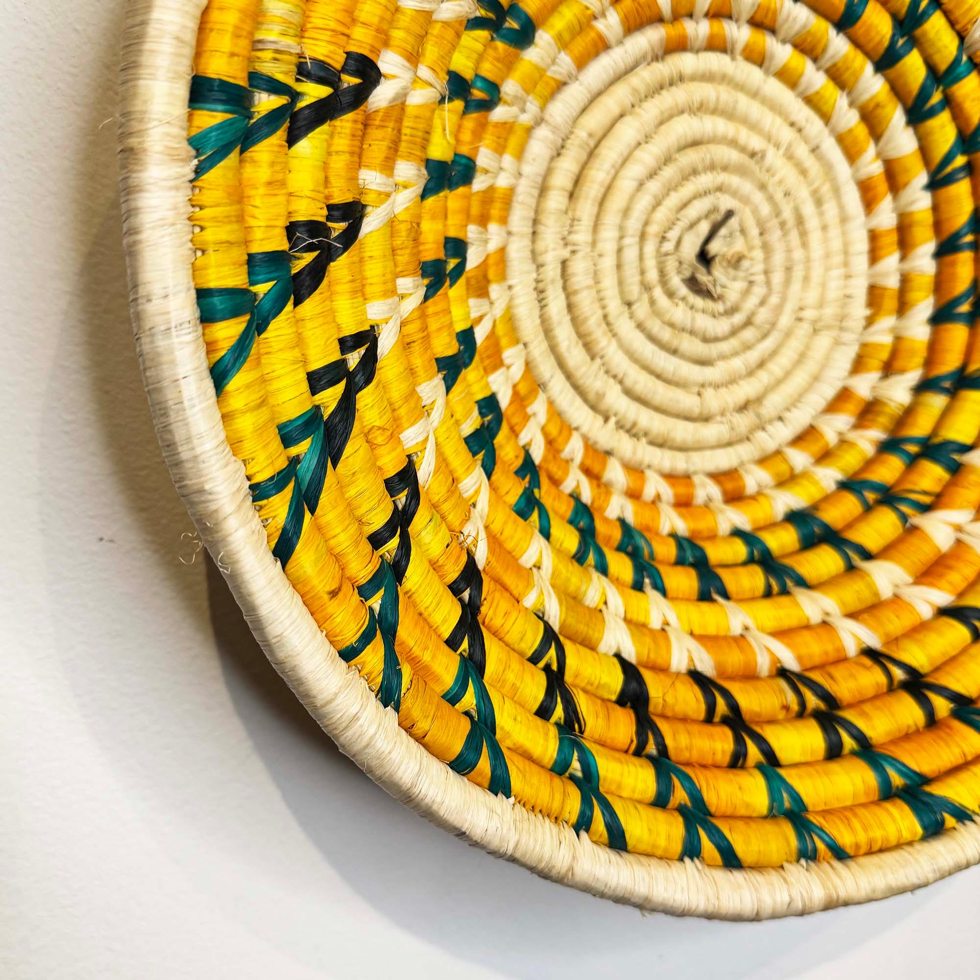 Yellow Woven Basket Handmade in Uganda as a wall decor idea with a close up