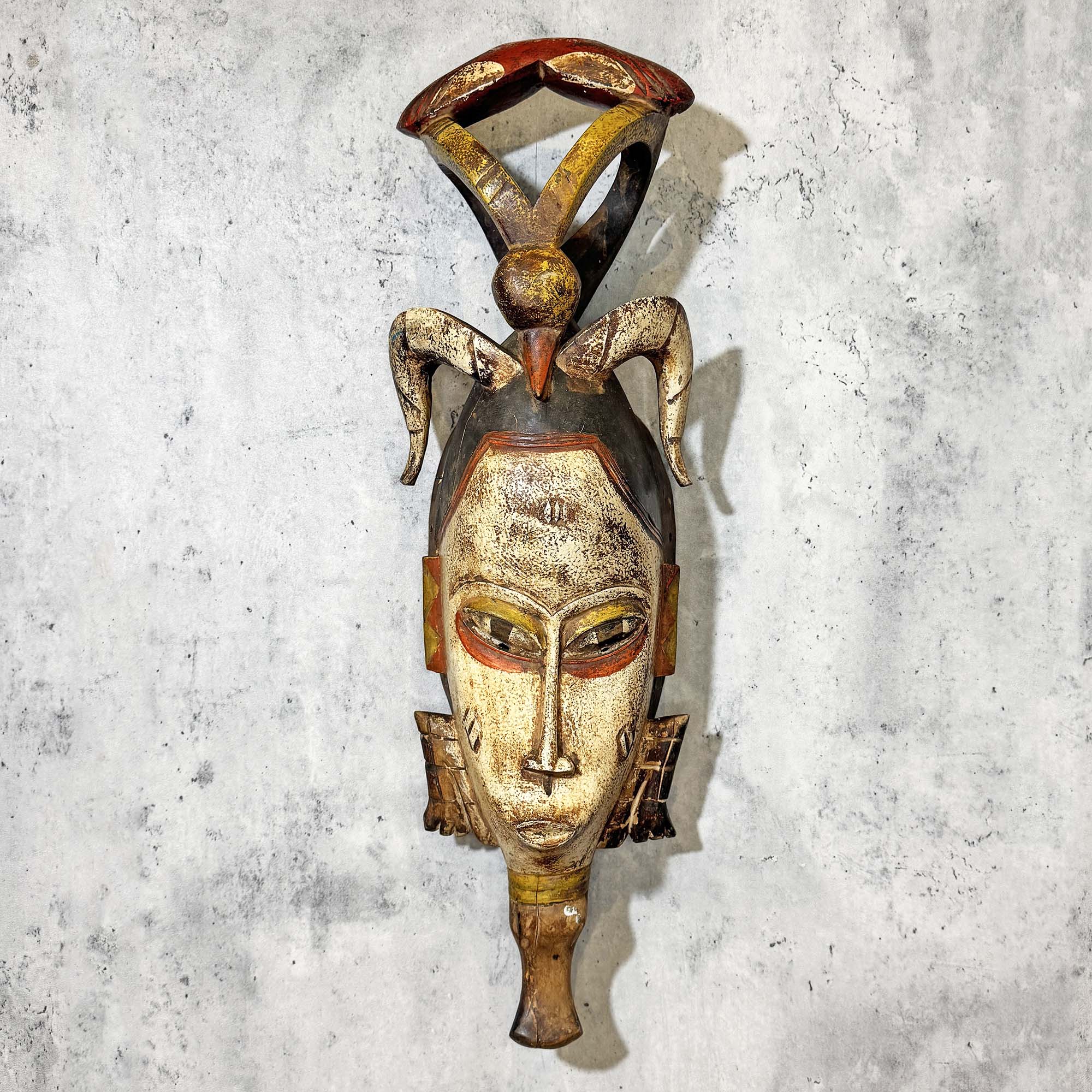 Guro Mask from Côte d'Ivoire hanging on a wall as a decoration