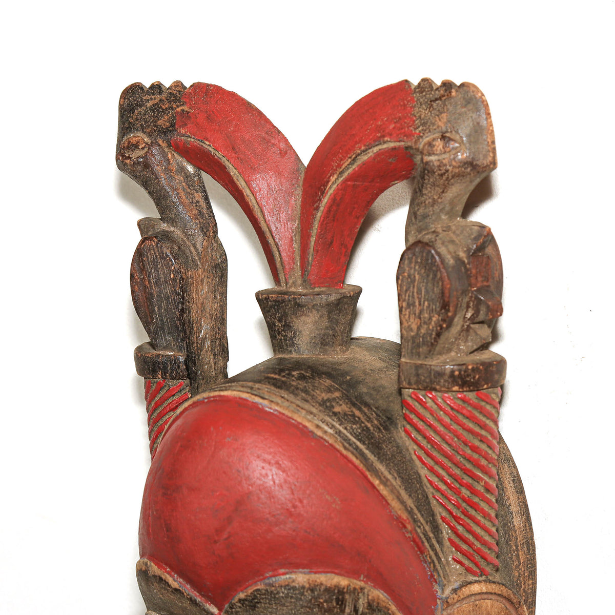 Red African Baule mask from Ivory Coast displayed as collectible West African tribal art