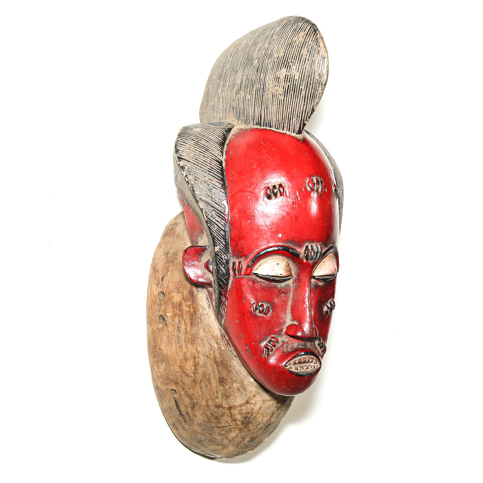 West African Baule mask with red surface and carved features