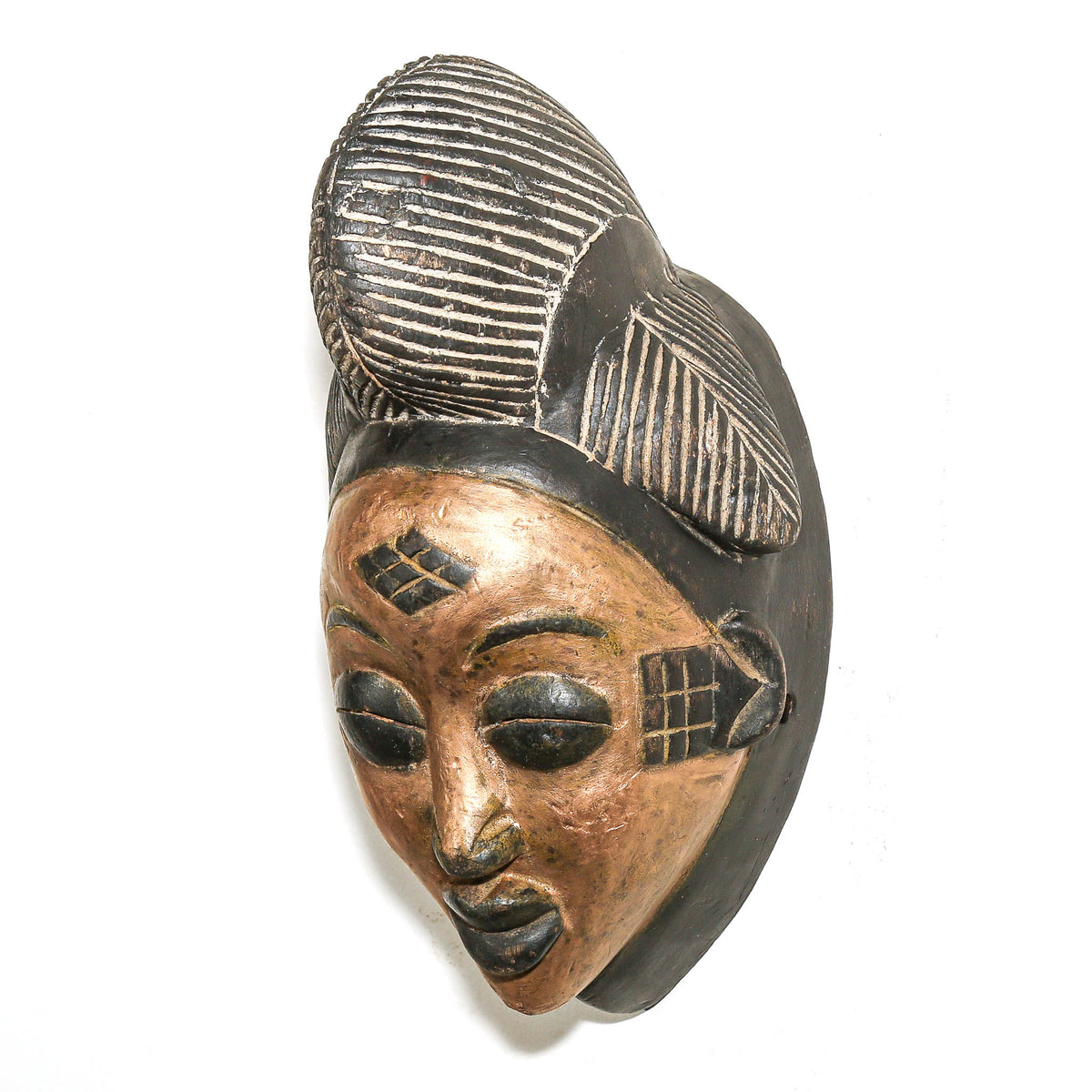 Hand-carved Gabonese Punu face mask featuring gold paint, smooth contours, and traditional regional styling
