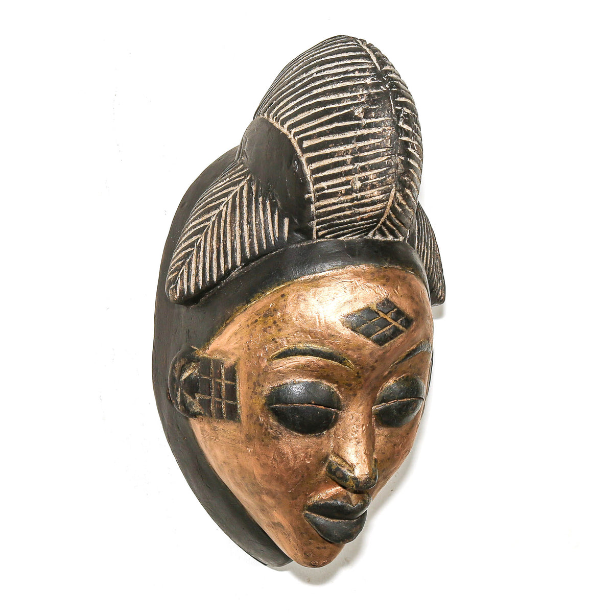 Traditional Punu mask with a gold painted face and graceful carved proportions, displayed as collectible African tribal art