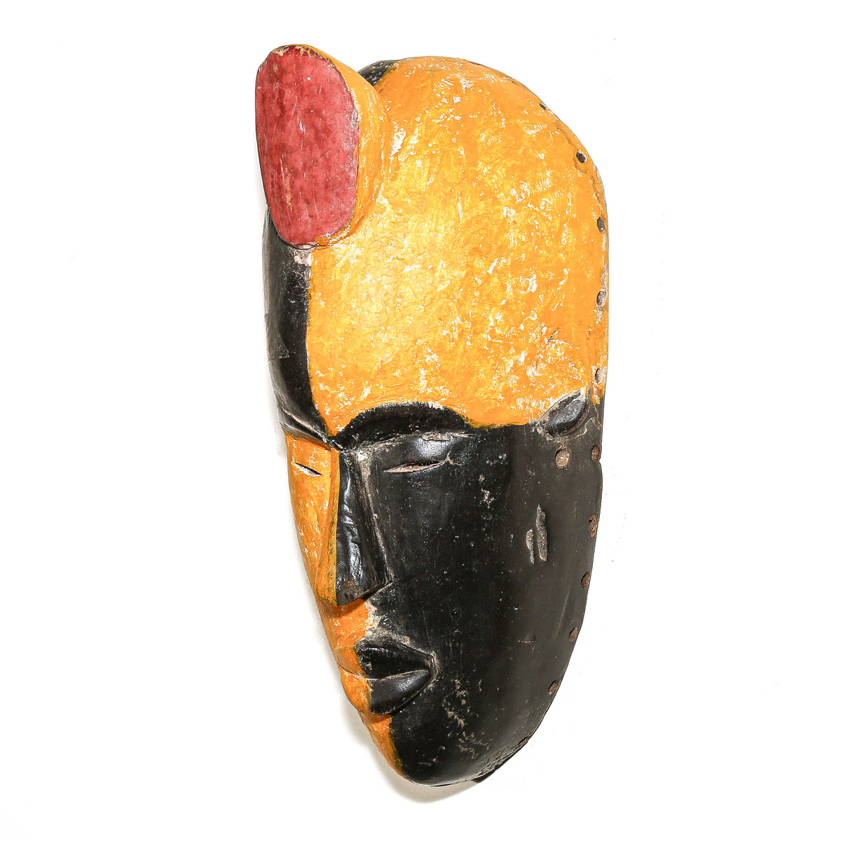 Traditional Igbo mask from Nigeria with expressive carved facial features and distinctive West African sculptural design