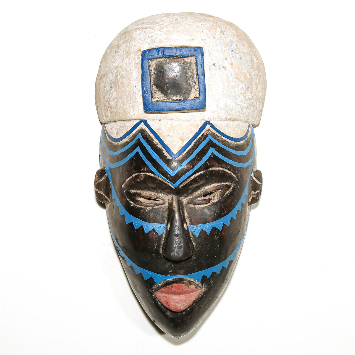 Traditional Igbo mask from Nigeria with expressive carved facial features and distinctive West African sculptural design