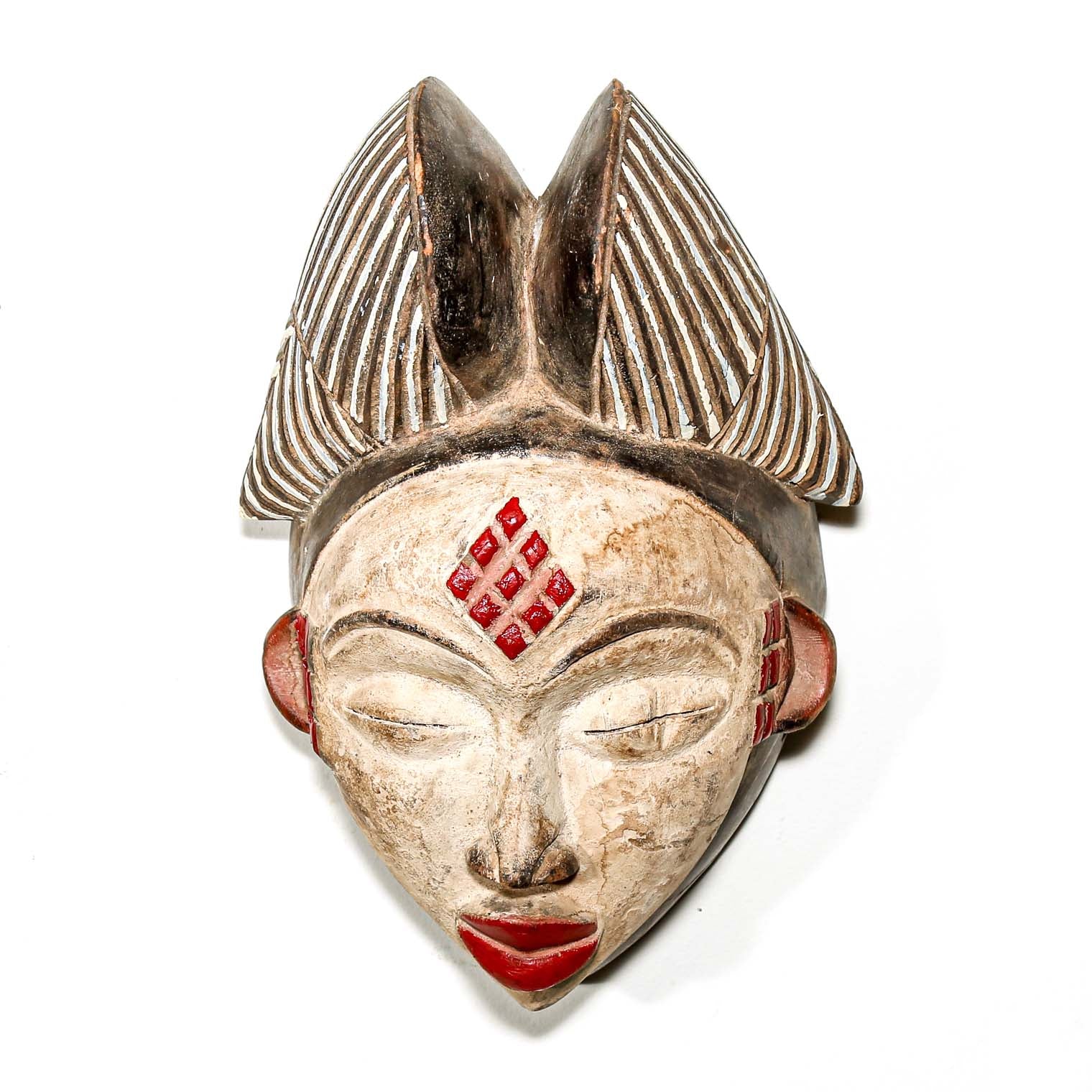 beautiful African mask with red accents on a white background