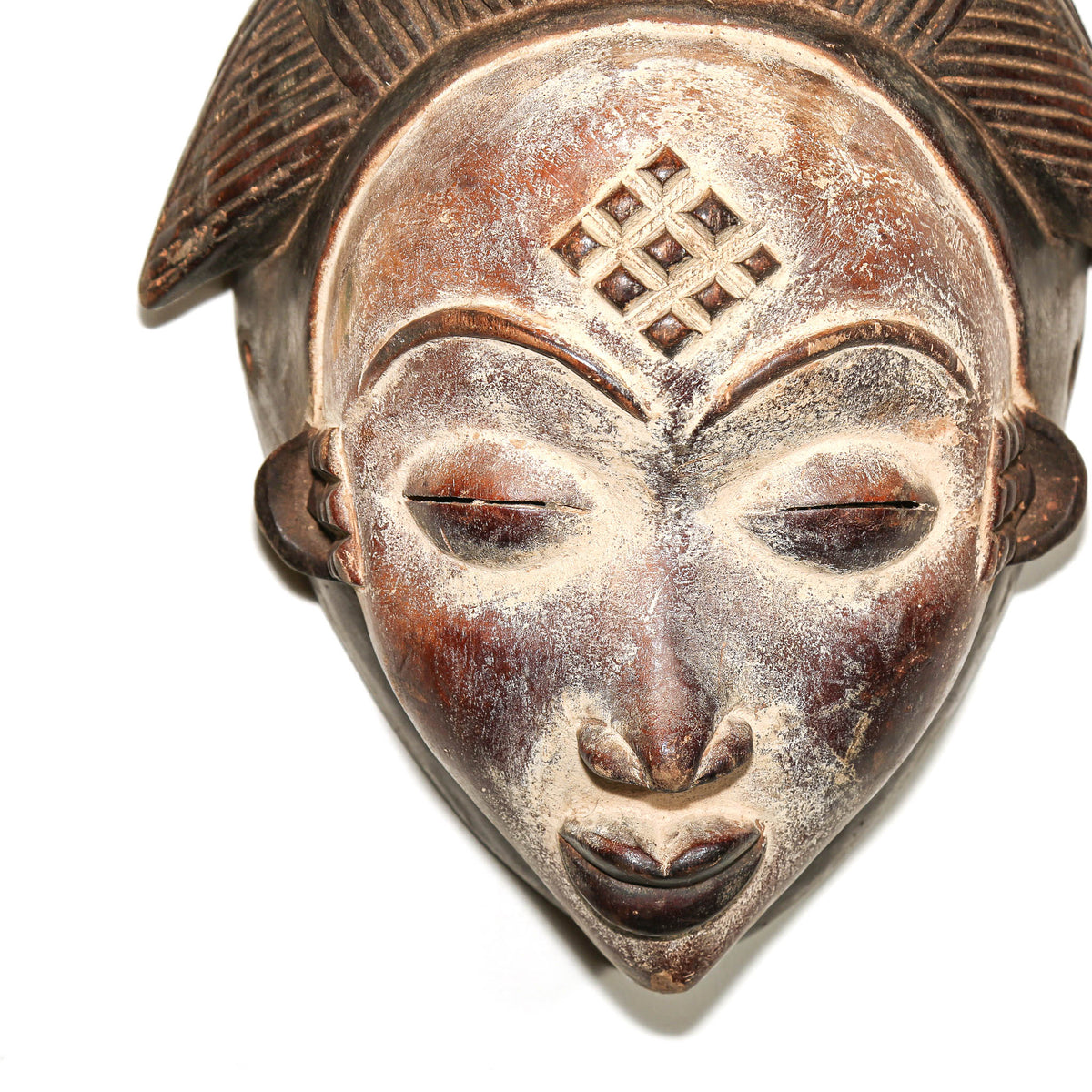Traditional large Punu ceremonial mask with finely carved features and a striking decorative presence in Central African art
