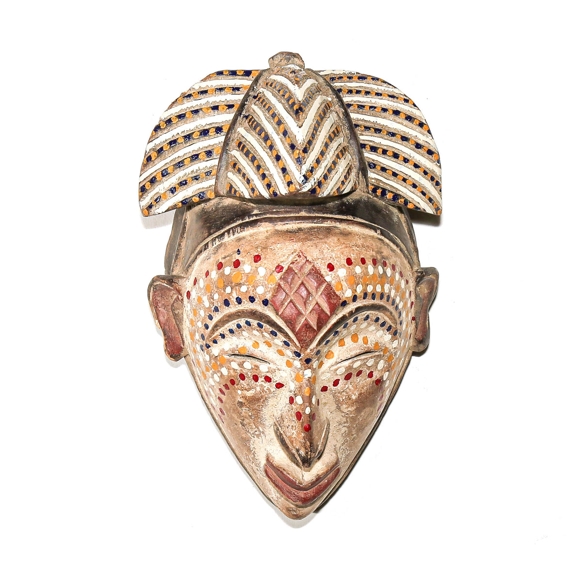 Traditional Punu face mask from Gabon featuring dotted decoration, elegant proportions, and carved wood construction