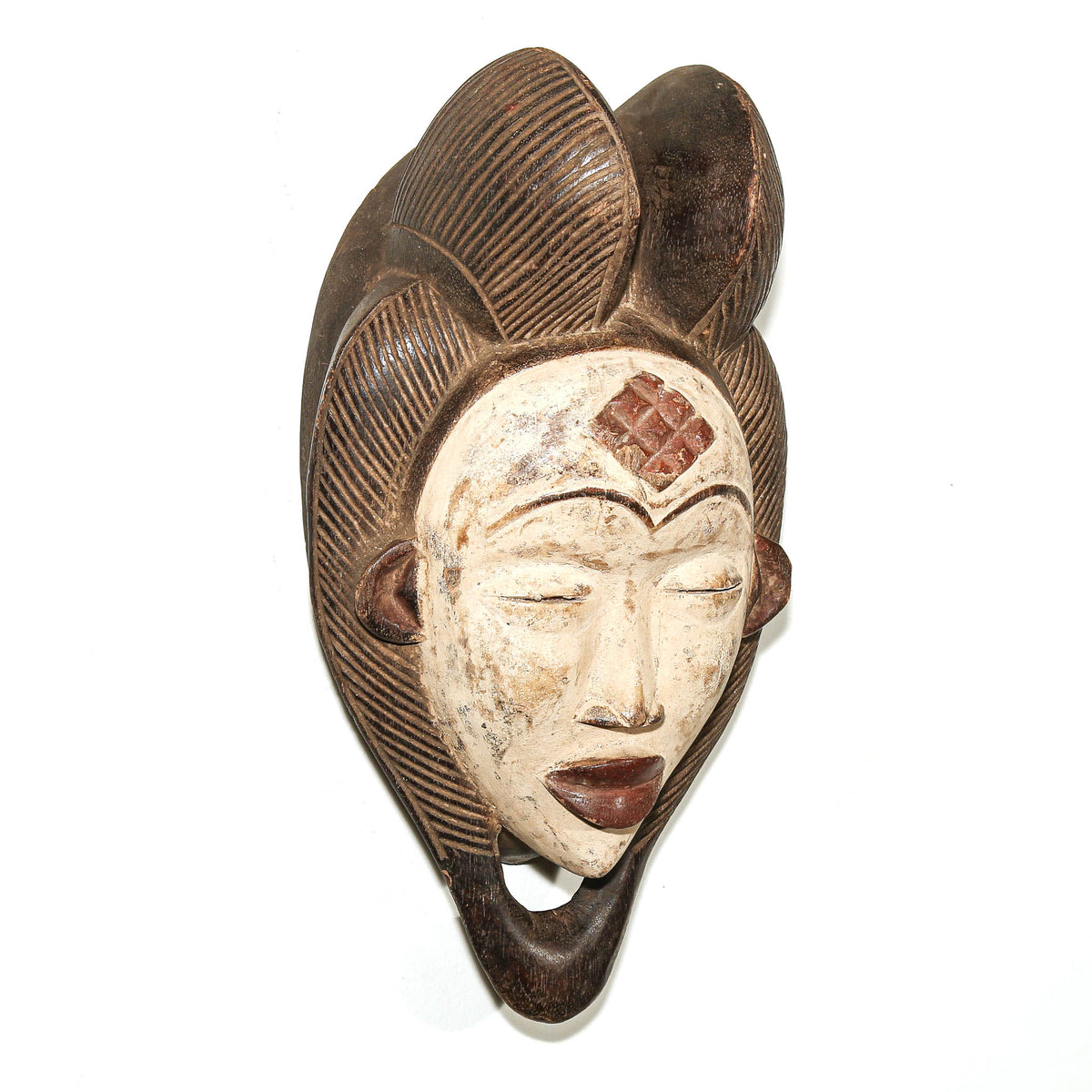 Hand-carved Punu African mask from Gabon featuring a graceful face and distinctive traditional details