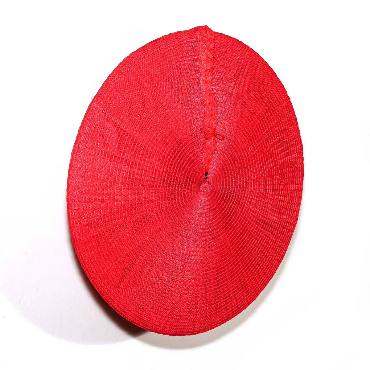 Red Zulu hat featuring vivid woven construction and a bold circular shape for decorative wall display