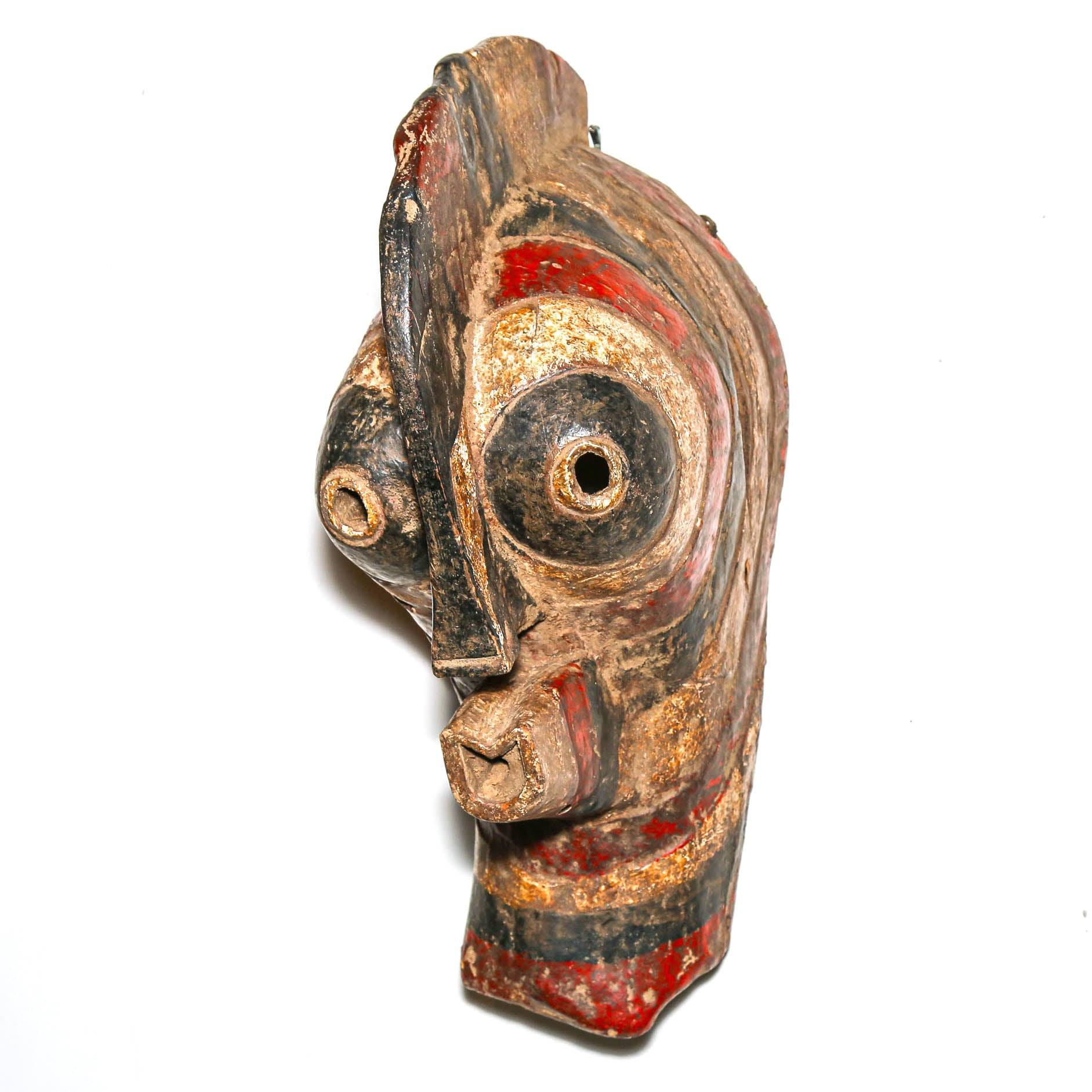 Wooden mask with painted features from tribal congo on a white background