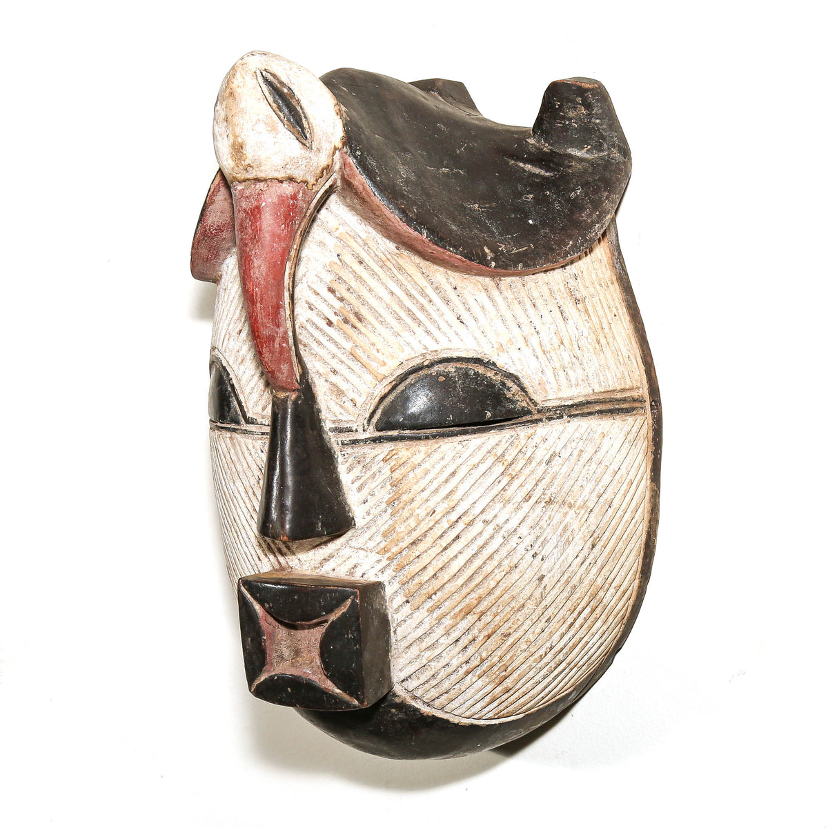 Traditional Songye African mask from Congo featuring a graphic black and white painted surface and sculptural carved form