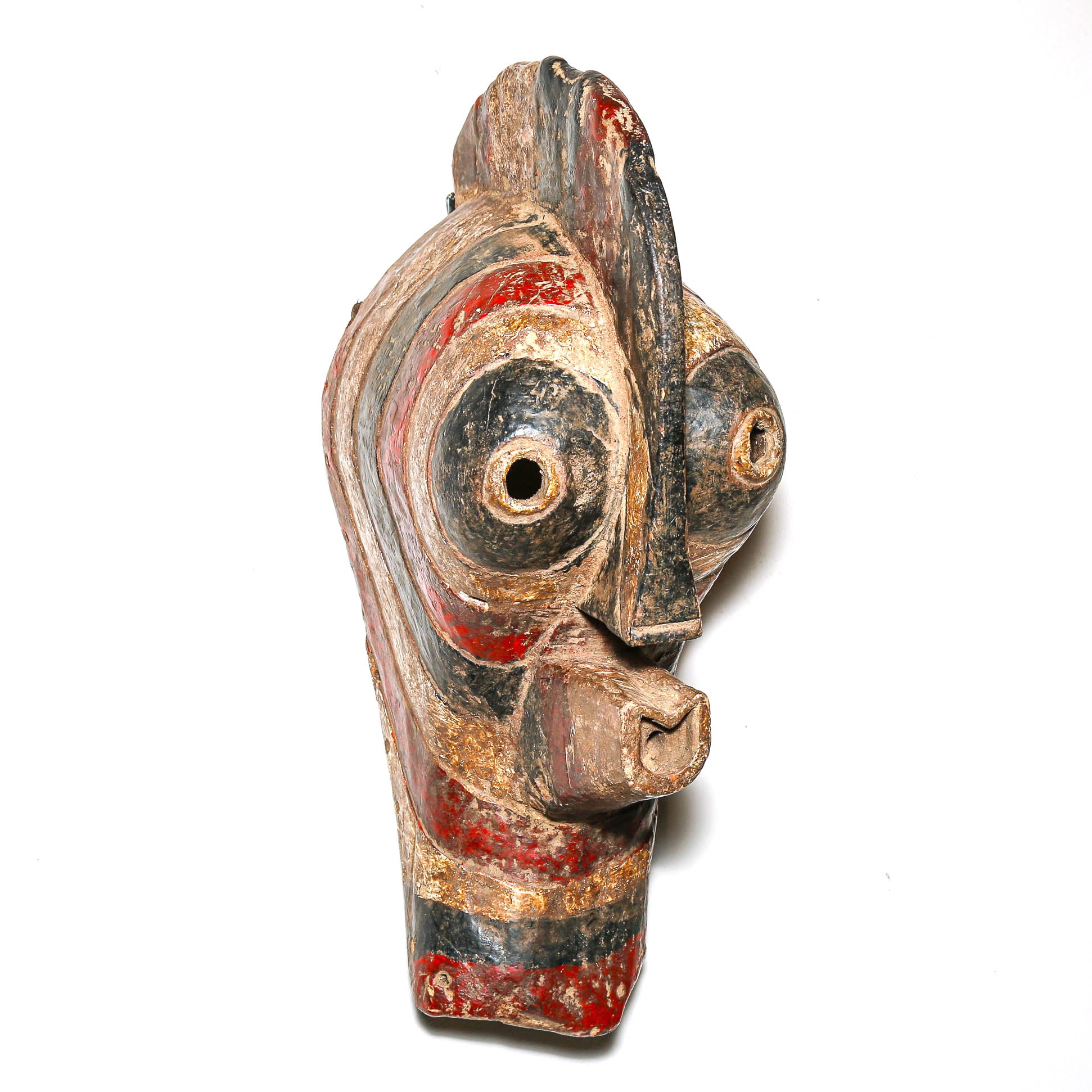 Wooden mask with red and black paint on a white background