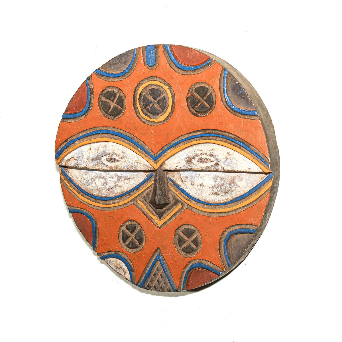 Hand-carved Teke face mask from Central Africa with colorful painted surface and stylized ceremonial design