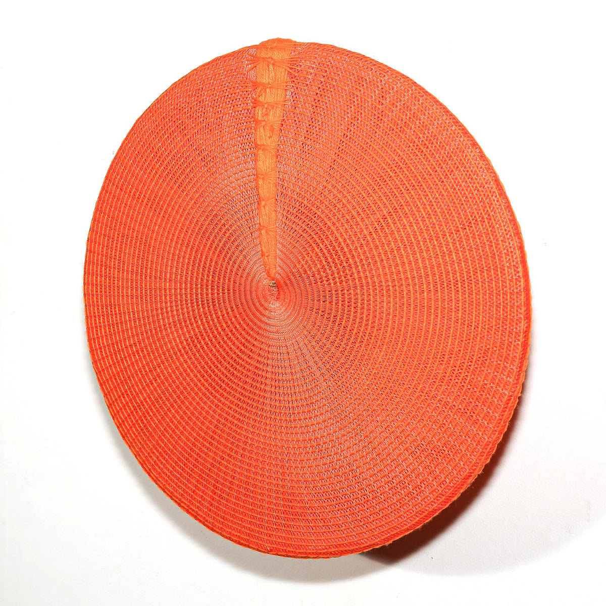 Traditional-style orange Zulu hat featuring vibrant woven construction and a bold circular shape for decorative wall display