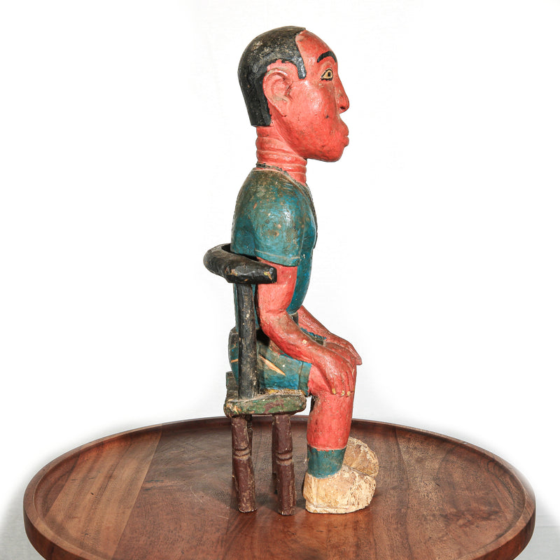 Colonial African figure on stool statue