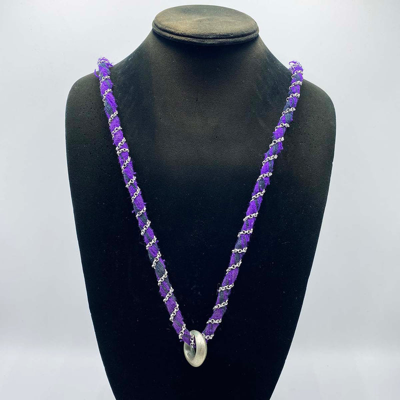 Ethiopian wedding ring worn on a purple necklace