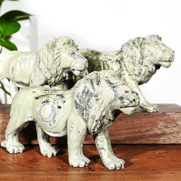 Small hand carvings of lions from Africa