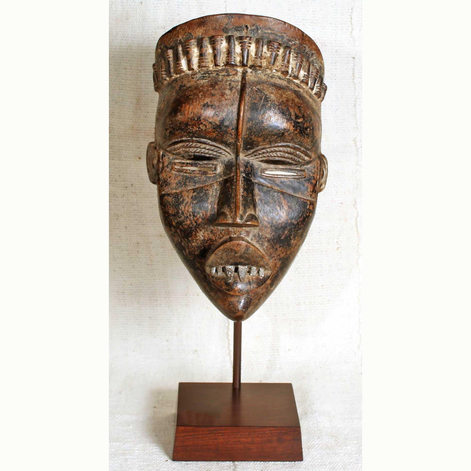 Bassa Mask from Liberia on a stand decorating a house