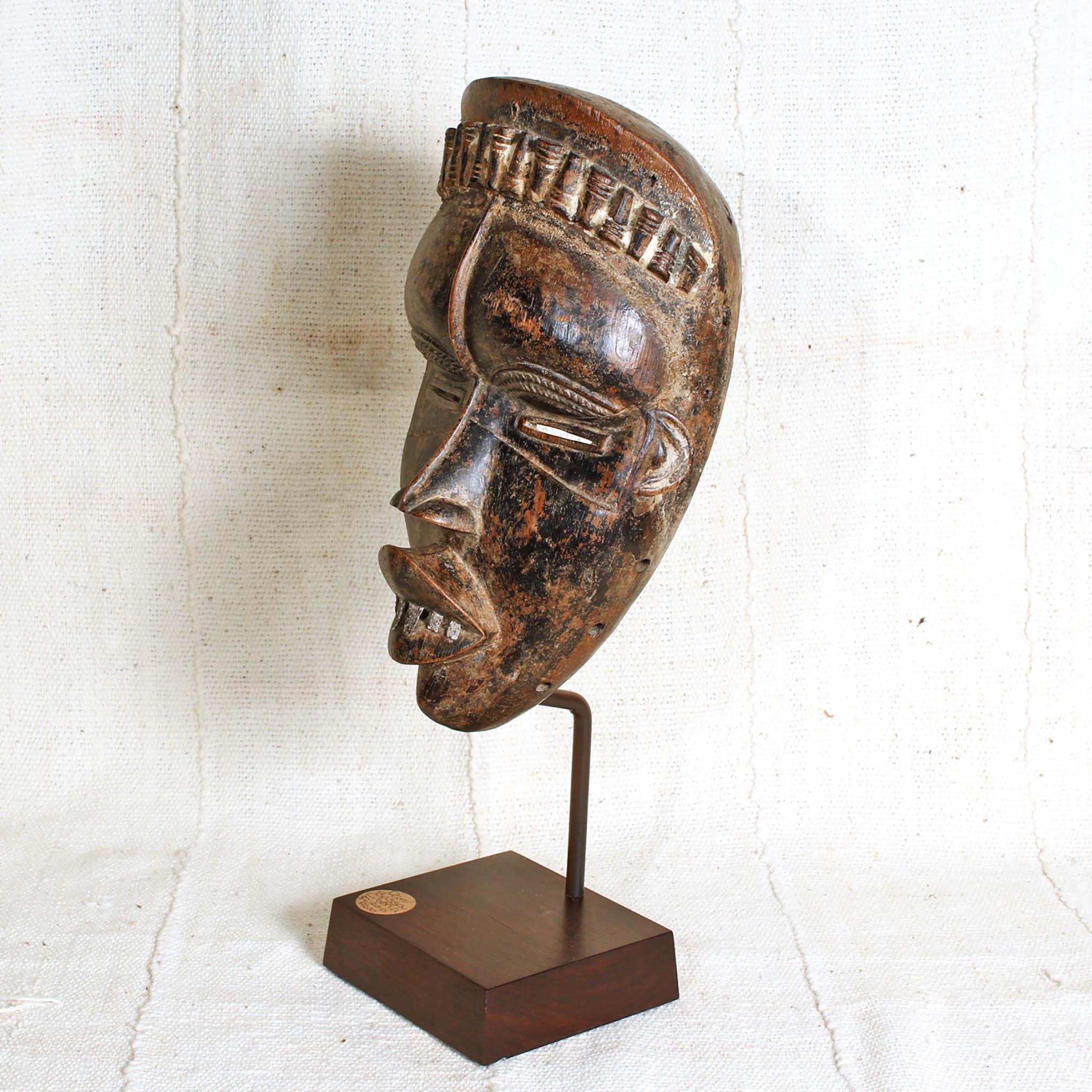 Bassa Mask from Liberia on a stand showing left side 
