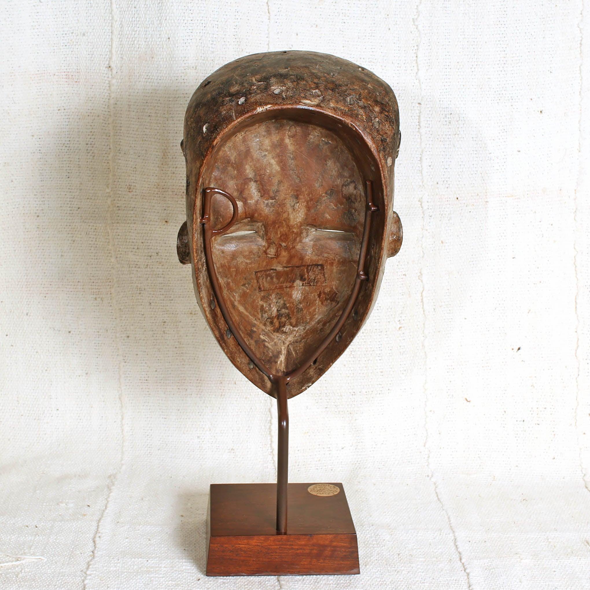 Bassa Mask from Liberia on a stand showing back 